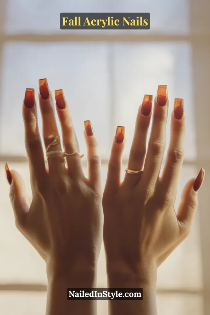 Square acrylic nails with translucent amber glass tips, backlit for jelly effect.