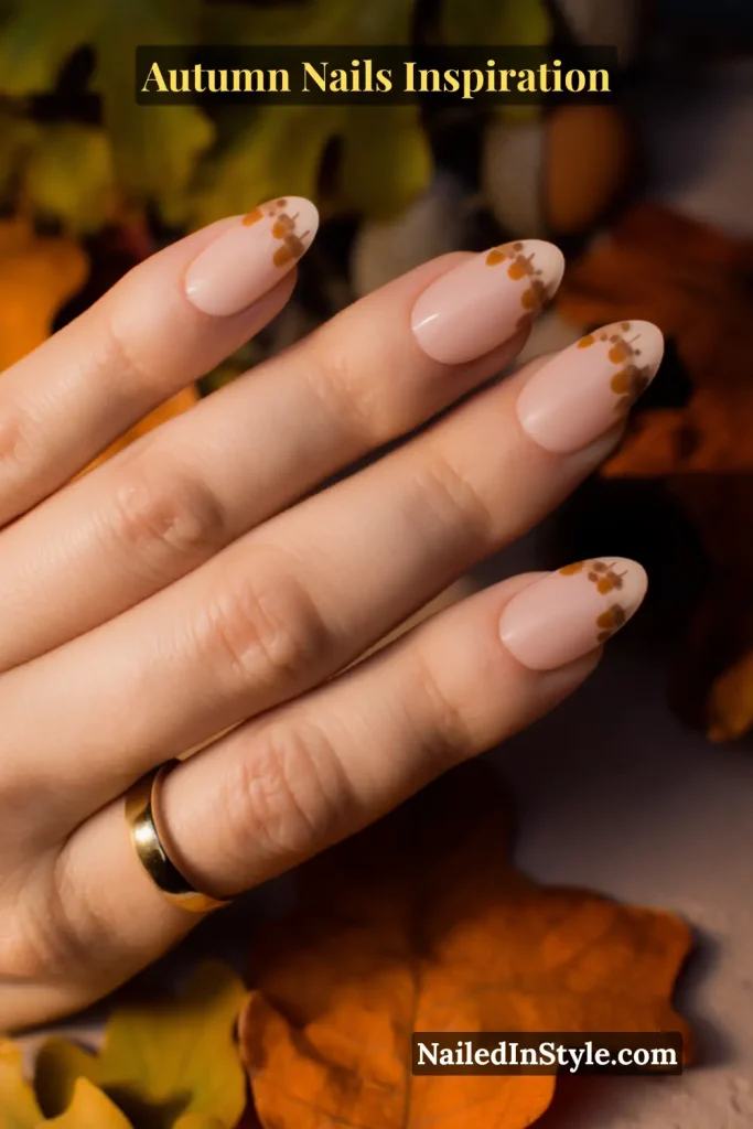 Nude nails with micro acorn silhouettes dotted along the tips for a subtle French manicure twist.