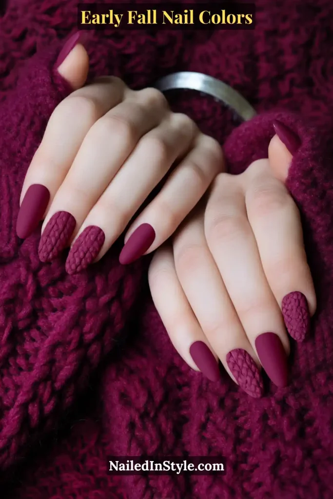 Early fall nail colors in mulberry matte with 3D knit accent texture, styled against a cozy berry sweater.