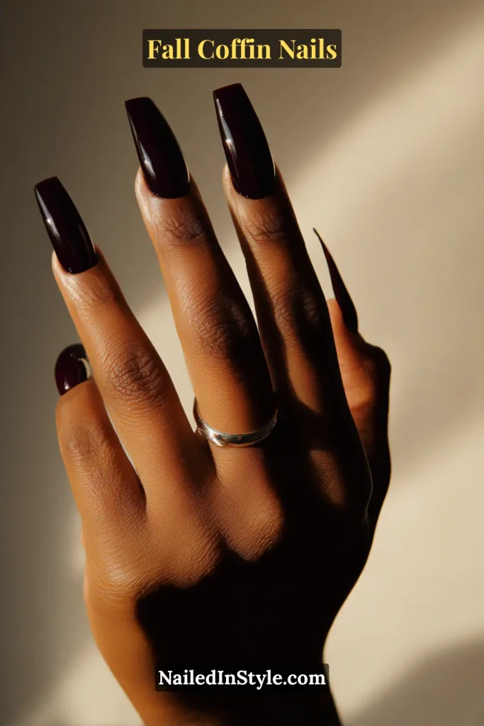 fall coffin nails in translucent blackberry jelly gloss catching soft window light, creating moody yet lightweight elegance
