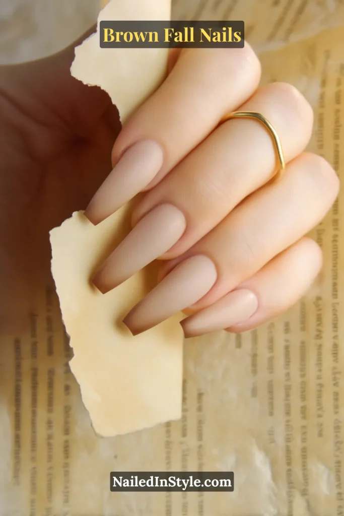 Vanilla-taupe nails with soft brown halo edges, creating a burnt-paper effect.