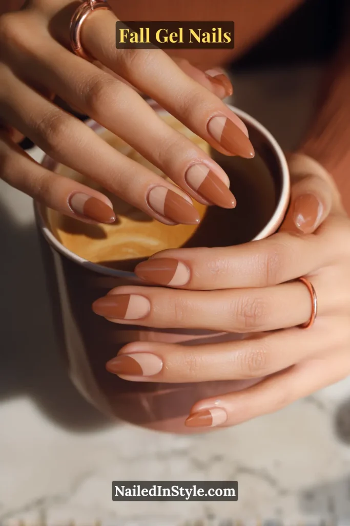 fall gel nails in nude with caramel half-moon design, oval shape, hand holding coffee cup