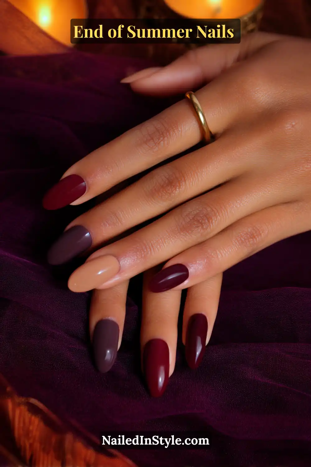 Burgundy and mocha nude nails on deep skin tone, creating a bold yet refined seasonal manicure.