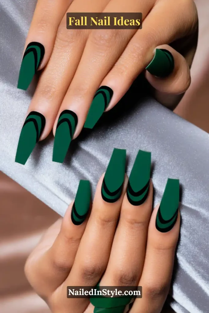 Fall Nail Ideas: 21 Gorgeous Looks to Try Now 14 Coffin nails with emerald green polish and negative space arc cutouts, styled with a satin sleeve and matching green statement ring.