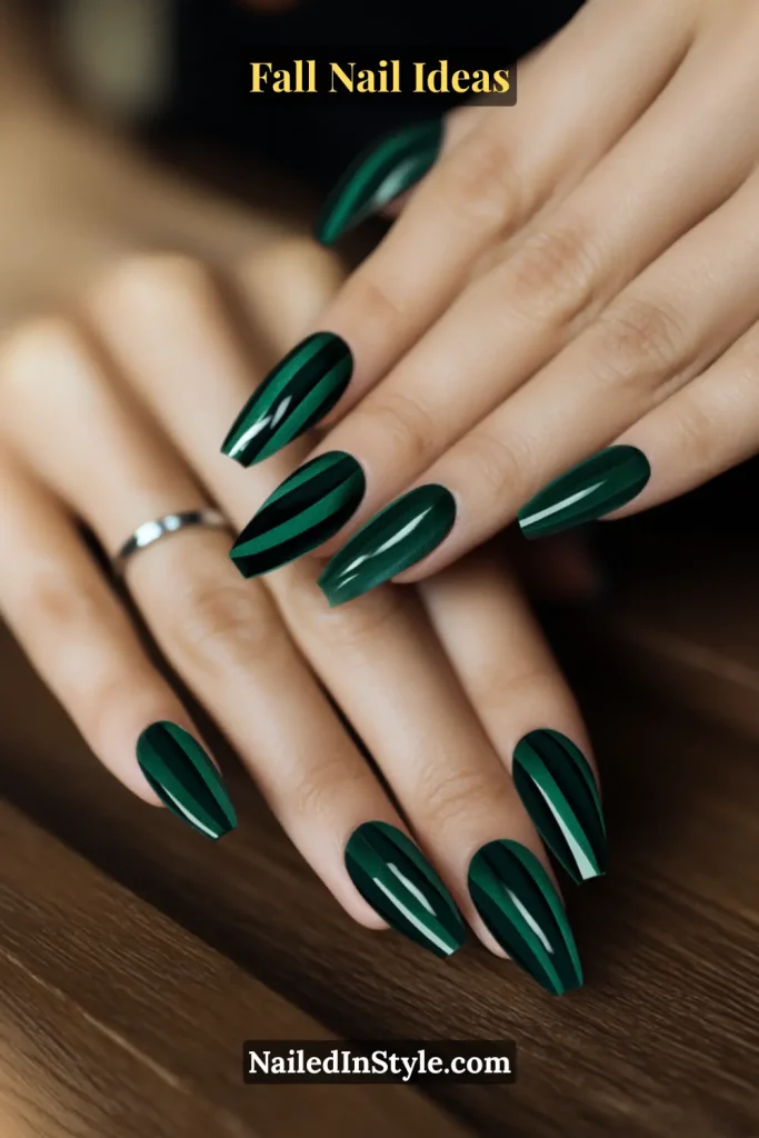 Fall Nail Ideas: 21 Gorgeous Looks to Try Now 2 Long almond nails in deep evergreen with magnetic velvet cat-eye stripe, hand resting on a wood table.