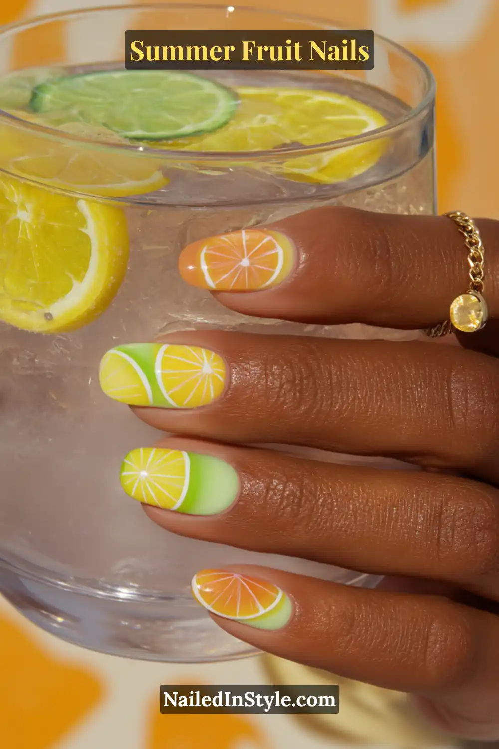 Bright summer nails featuring vivid lemon, lime, and orange slice designs on a yellow, green, and orange gradient base.