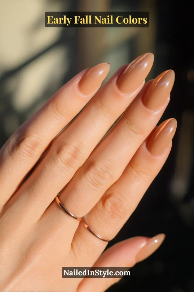 Early fall nail colors in maple-brown chrome French tips, styled under sunlight to highlight the metallic sheen.