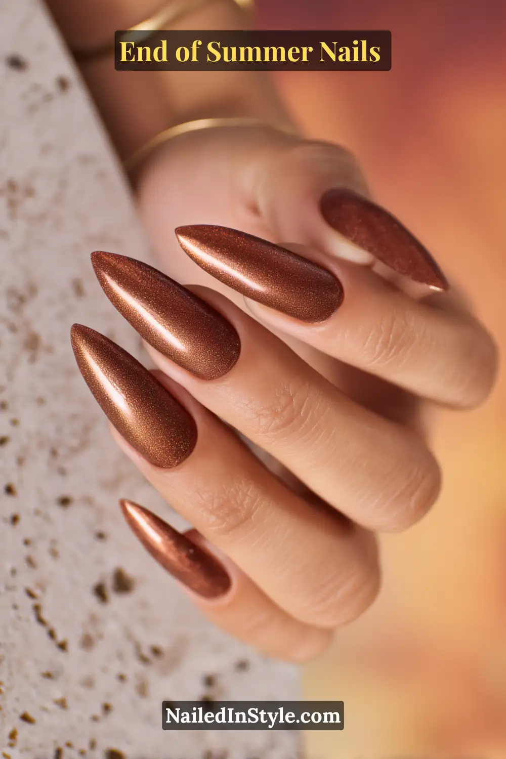 Copper and bronze shimmer nails on medium skin tone, enhancing golden undertones for an elegant end of summer look.