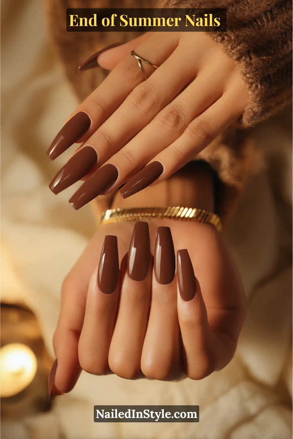 Close-up of two hands with long coffin-shaped nails painted in glossy mocha brown polish.