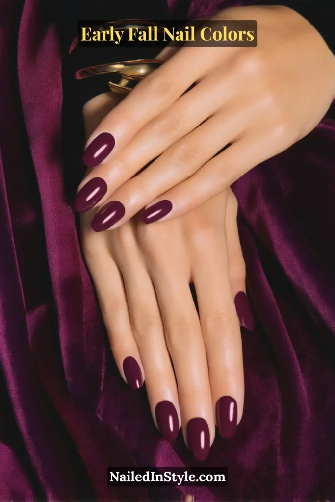 Early fall nail colors in deep mulberry berry crème with satin topcoat, styled with velvet fabric cuff.