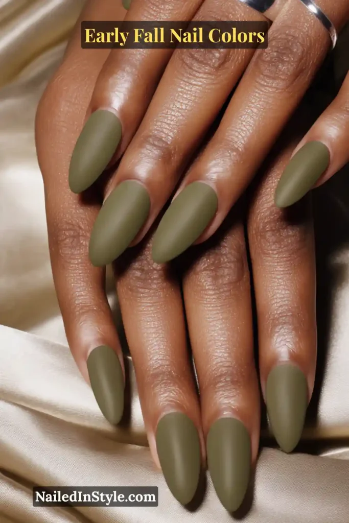 Early fall nail colors in smoky olive cat-eye with a magnetic shimmer stripe, styled with a satin sleeve and silver ring.