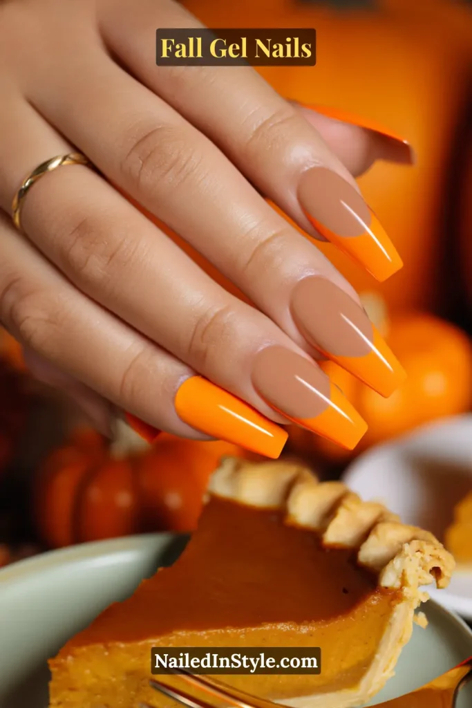fall gel nails in nude base with bright orange French tips, coffin shape holding a fork over pumpkin pie slice