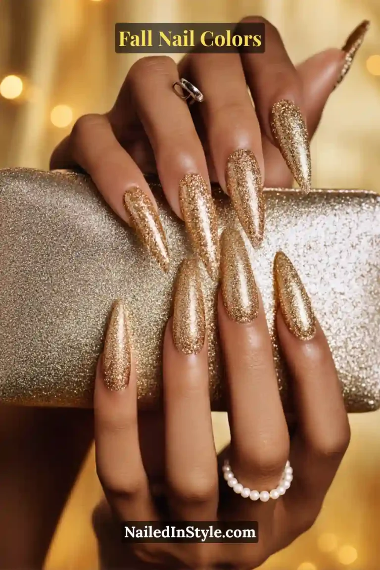 Glossy rust red nails on tan skin holding a small pumpkin, inspired by autumn leaves.