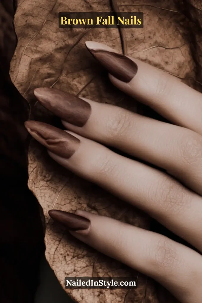 Brown fall nails with elongated tobacco leaf outline over a greige base.