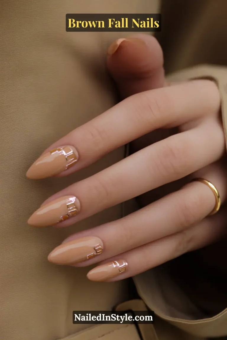 Camel brown fall nails with glossy finish and tiny metallic buckle details, inspired by trench coat belts.