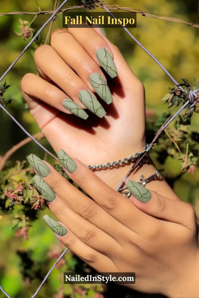 Matte sage green nails with fine olive line art resembling trellis vines.