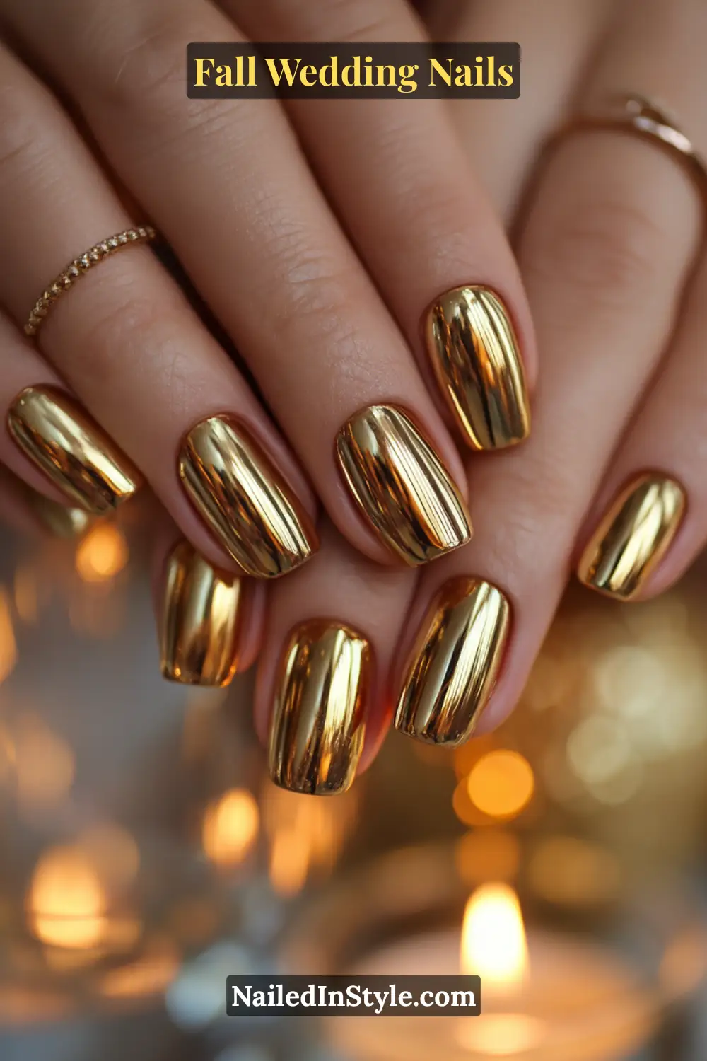 Close-up of fall wedding nails with high-shine gold chrome polish, bride’s hands glowing against candlelight.