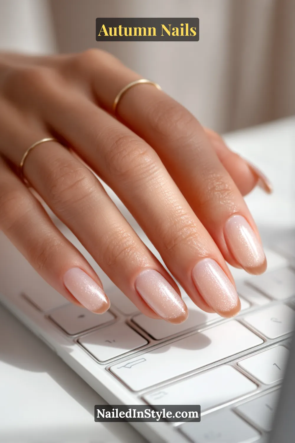 Close-up of cinnamon sugar micro-French autumn nails with sheer nude base and subtle cinnamon tips, perfect for work.