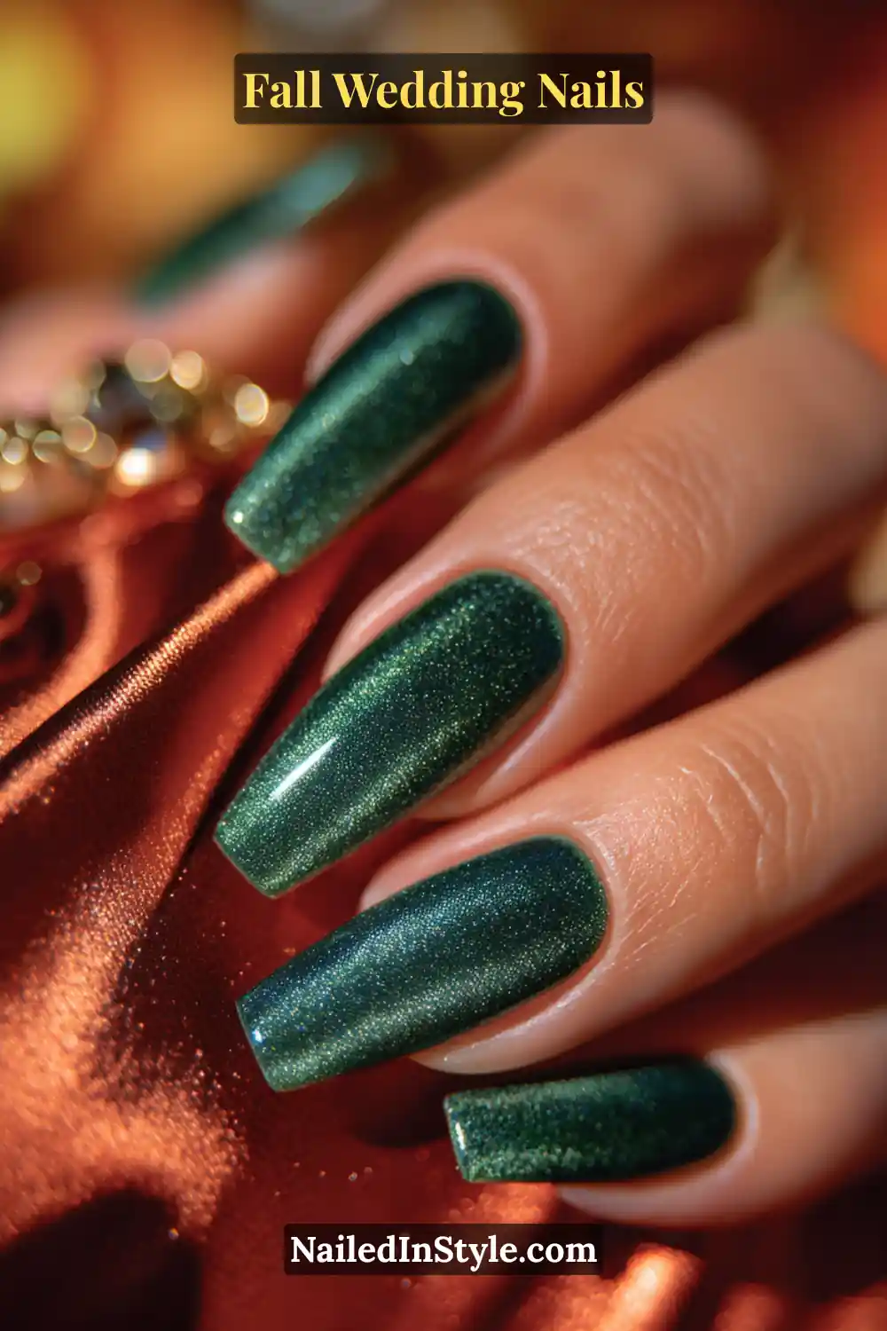 Close-up of fall wedding nails in deep emerald green with a magnetic velvet cat-eye shimmer, bridesmaid holding satin clutch.
