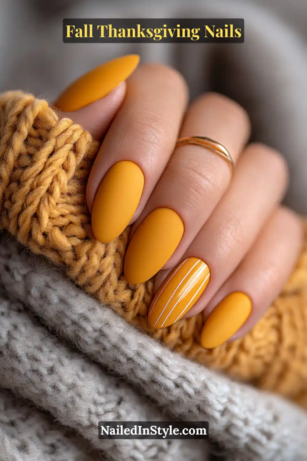 Close-up of saffron matte lines Thanksgiving nails with matte saffron base and glossy vertical accents, styled against a wool scarf.