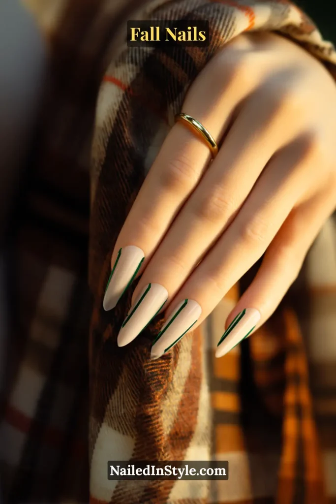 Coffin fall nails in Pine Needle Linear with forest-green vertical lines on each nail, styled against a plaid scarf backdrop.
