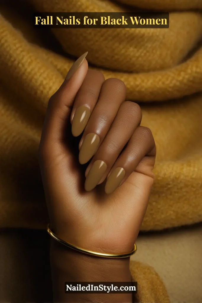 Fall nails for Black women featuring translucent olive square-shaped nails, styled against a wool scarf.