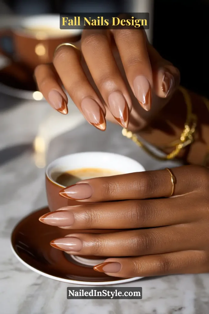 Fall Nails Design: Bold, Chic & Gorgeous Ideas 6 Fall nails design featuring nude almond nails with glossy caramel half-moon arcs at the base, styled elegantly with a coffee saucer detail.