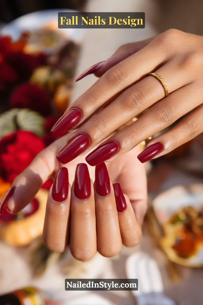 Fall Nails Design: Bold, Chic & Gorgeous Ideas 12 Fall nails design featuring bold cranberry gloss nails styled with a Thanksgiving tablescape in the background.