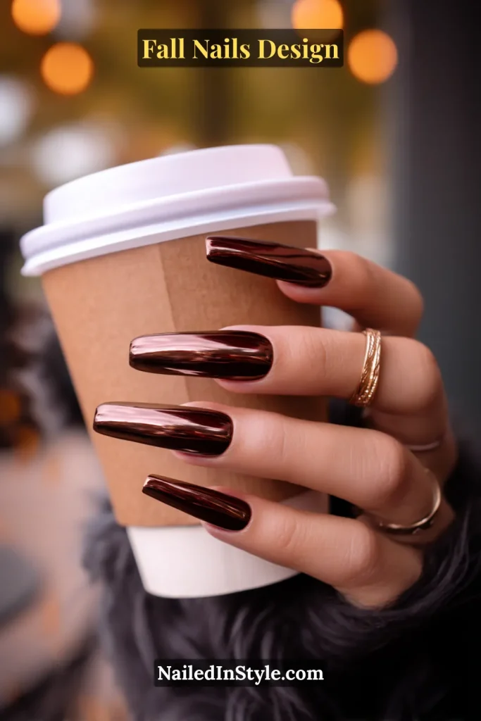 Fall Nails Design: Bold, Chic & Gorgeous Ideas 1 Fall nails design with espresso chrome coffin nails in dark coffee brown, styled while holding a latte cup in a cozy café setting.
