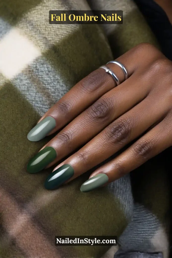 Fall ombre nails with sage to forest green vertical gradient, styled against a plaid scarf.