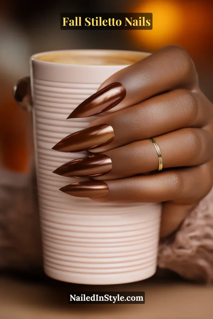 Caramel stiletto nails with molten chrome sheen, styled holding a ribbed latte mug.
