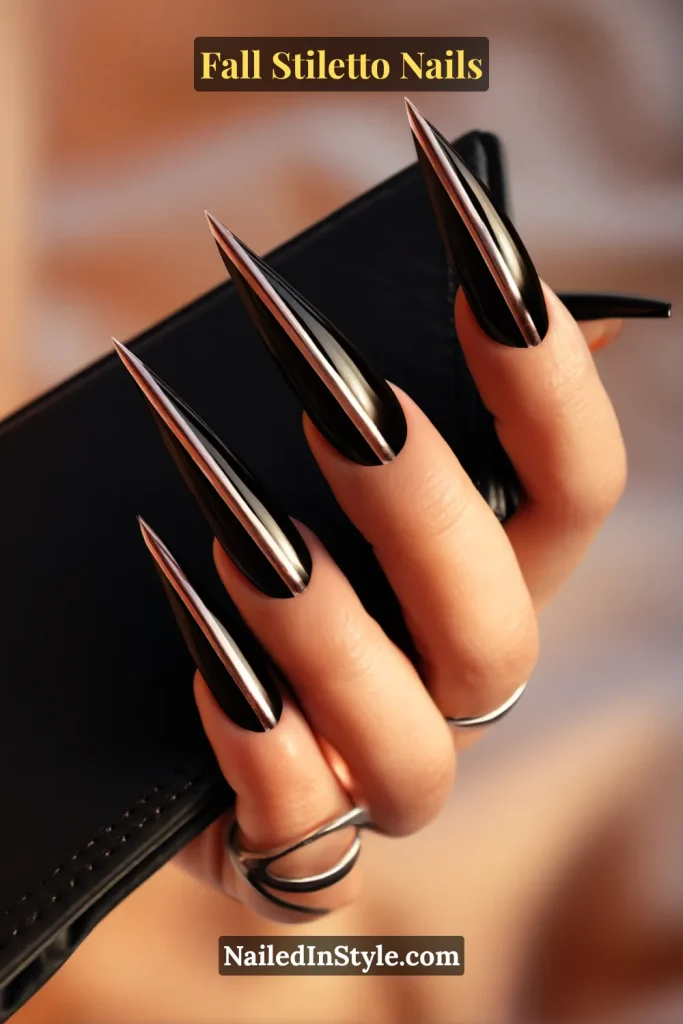 Inky black stiletto nails with a single metallic vertical bar, styled holding a sleek cardholder.