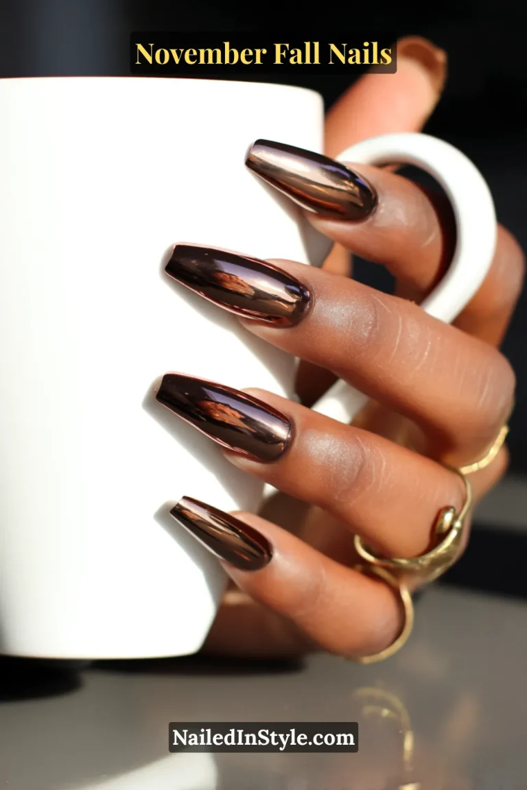 November fall nails in deep espresso brown with chrome mirror glaze, styled on long coffin nails holding a ceramic latte mug.
