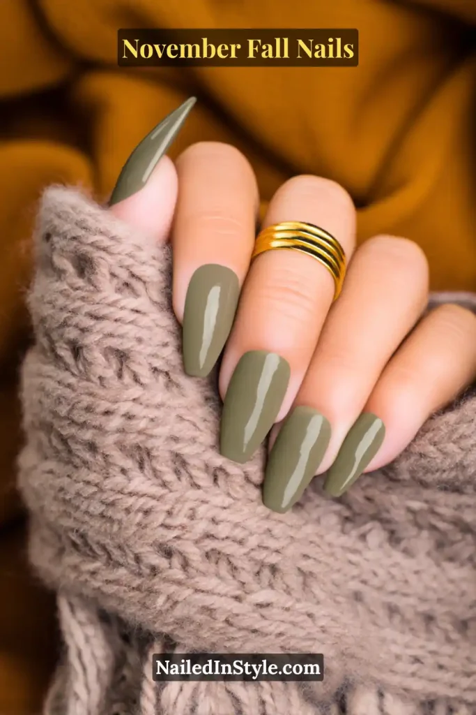 November fall nails in a sheer olive base with slim French tips, styled against a cozy cable-knit scarf.