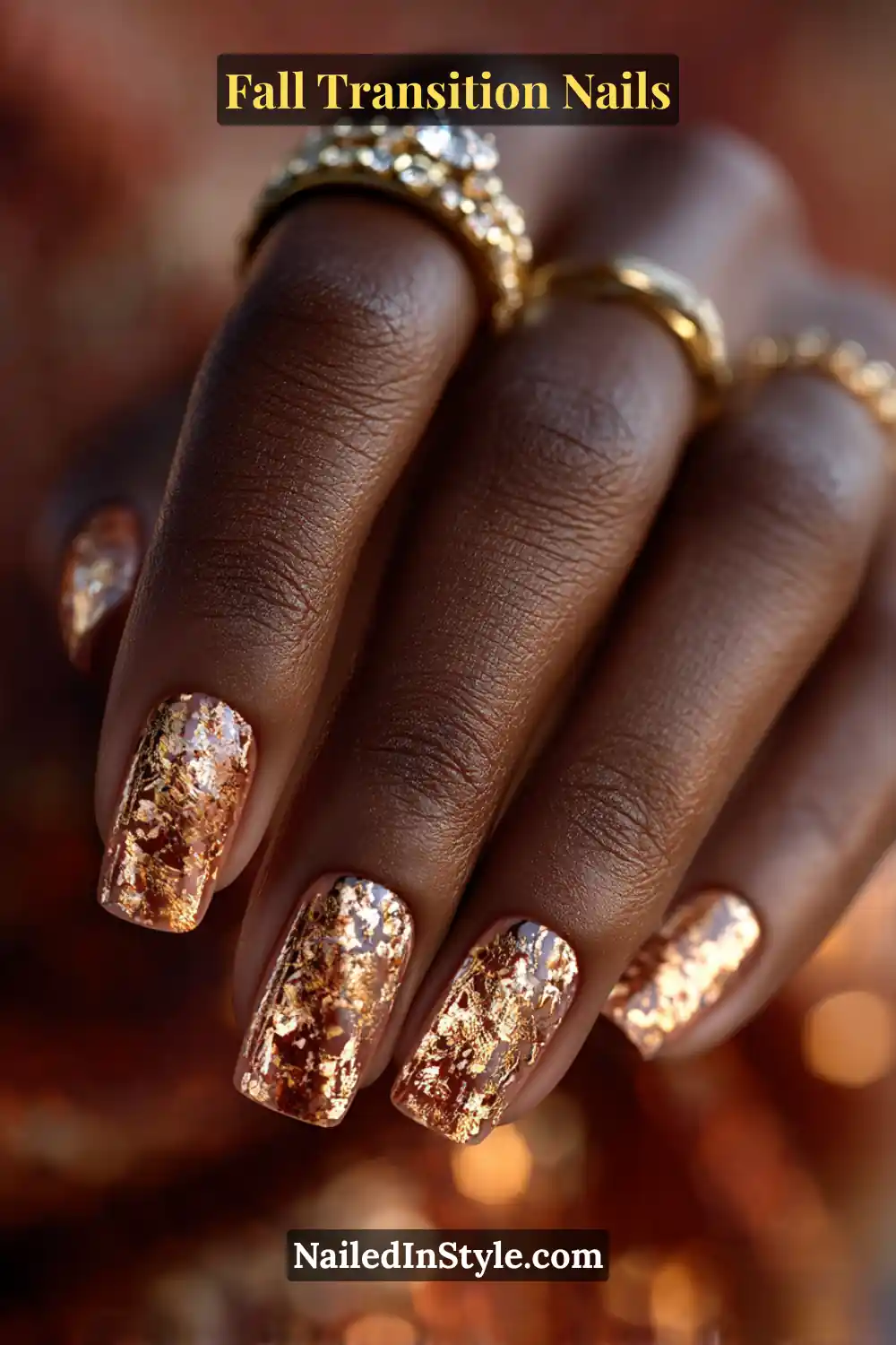 Short square nails in sheer amber tones layered with bronze and gold shattered foil pieces, creating a dimensional 3D reflective finish under warm light.