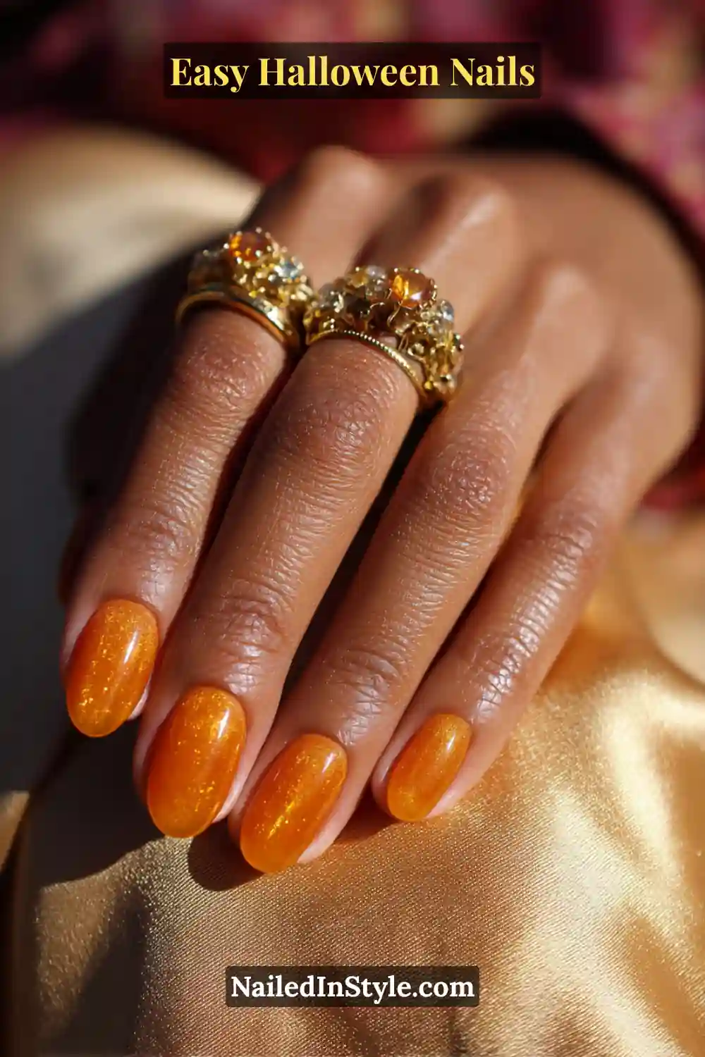 Oval nails painted in glossy amber jelly polish with a translucent, candlelit glow and soft shimmer, perfect for Easy Halloween Nails.