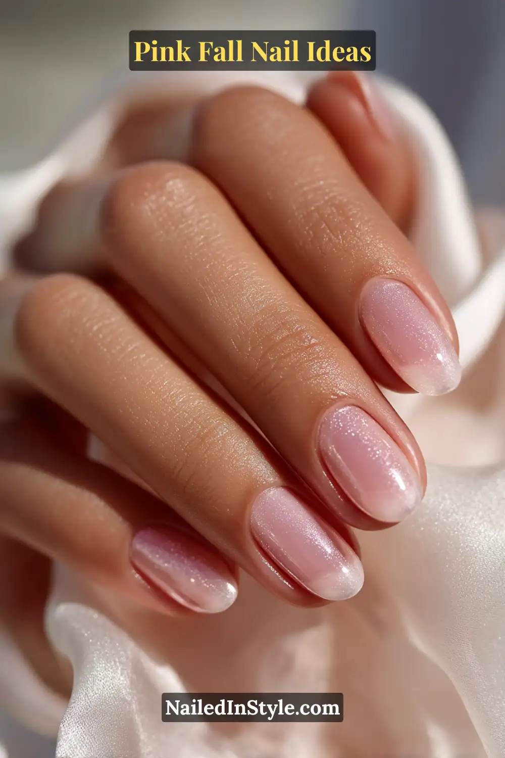 Pink Fall Nail Ideas: Chic, Fast & Photogenic 2025 12 Medium oval nails painted in sheer ballet pink with a soft pearl satin overlay, glowing delicately against a silk scarf for a romantic fall look.