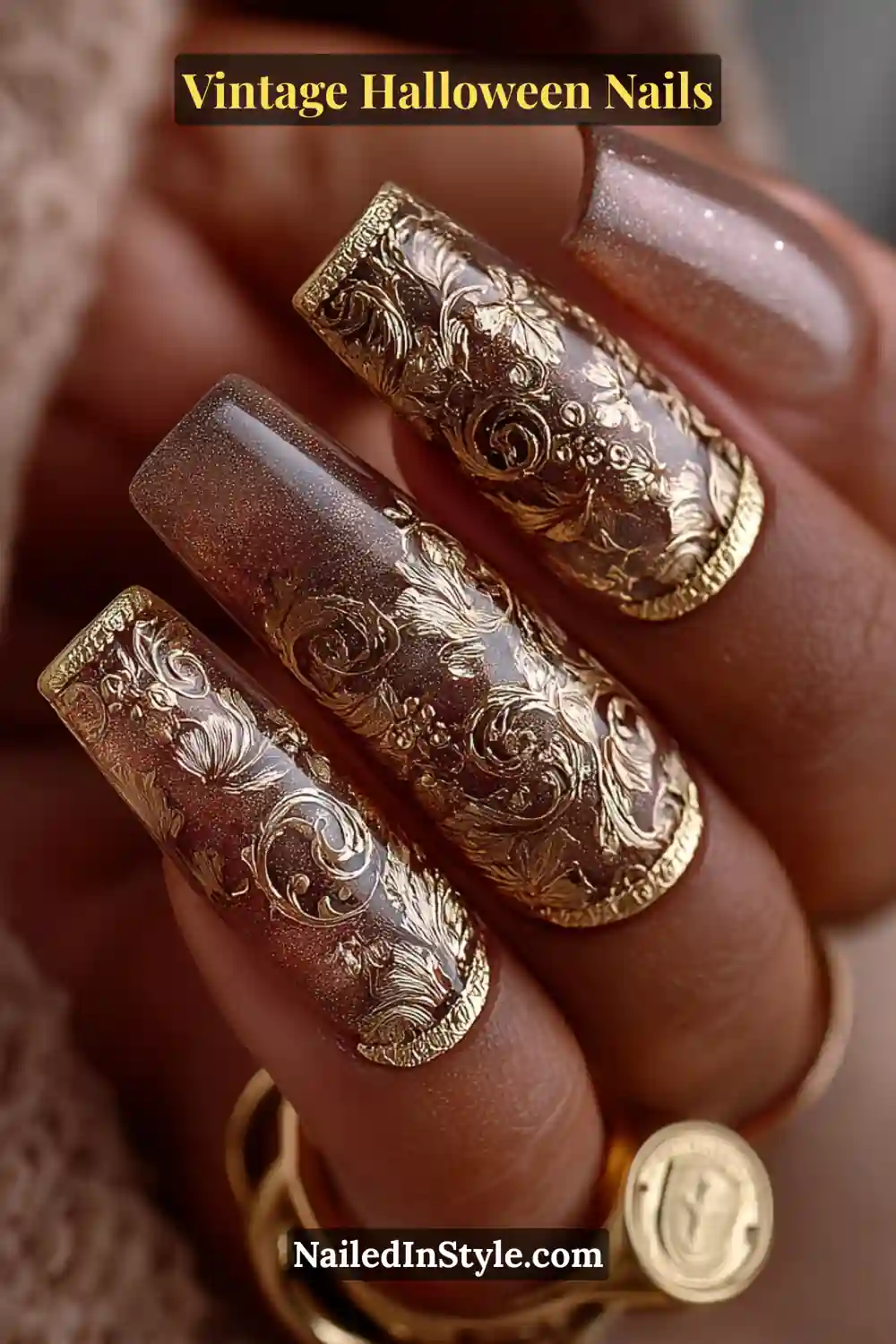 Long coffin nails in glossy taupe adorned with raised antique gold filigree cuffs along the cuticle, creating a 3D baroque texture perfect for vintage Halloween opulence.
