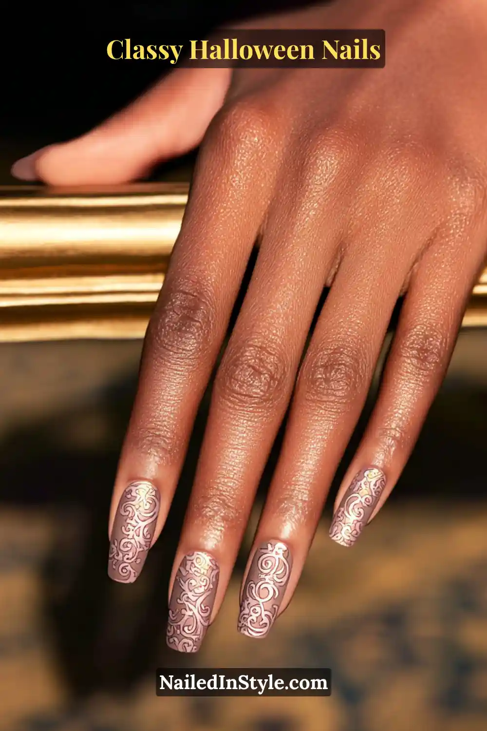 Medium coffin nails painted in soft cocoa with intricate bronze foil filigree detailing in raised 3D texture — a lavish, baroque-inspired design that radiates warmth and sophistication.