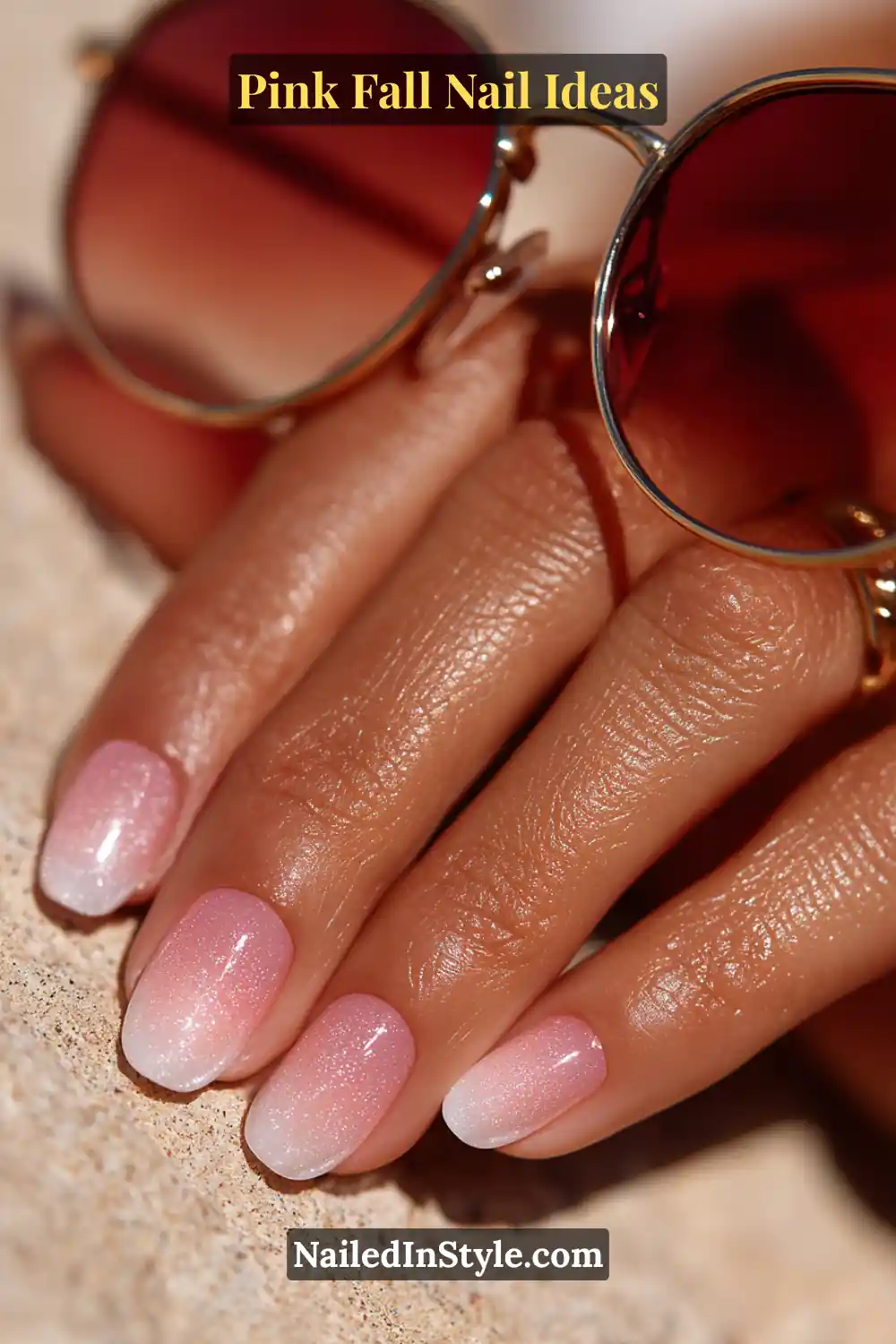 Pink Fall Nail Ideas: Chic, Fast & Photogenic 2025 9 Medium almond nails with a soft bubblegum pink aura effect fading to white at the tips, glowing subtly in sunlight beside mirrored sunglasses.