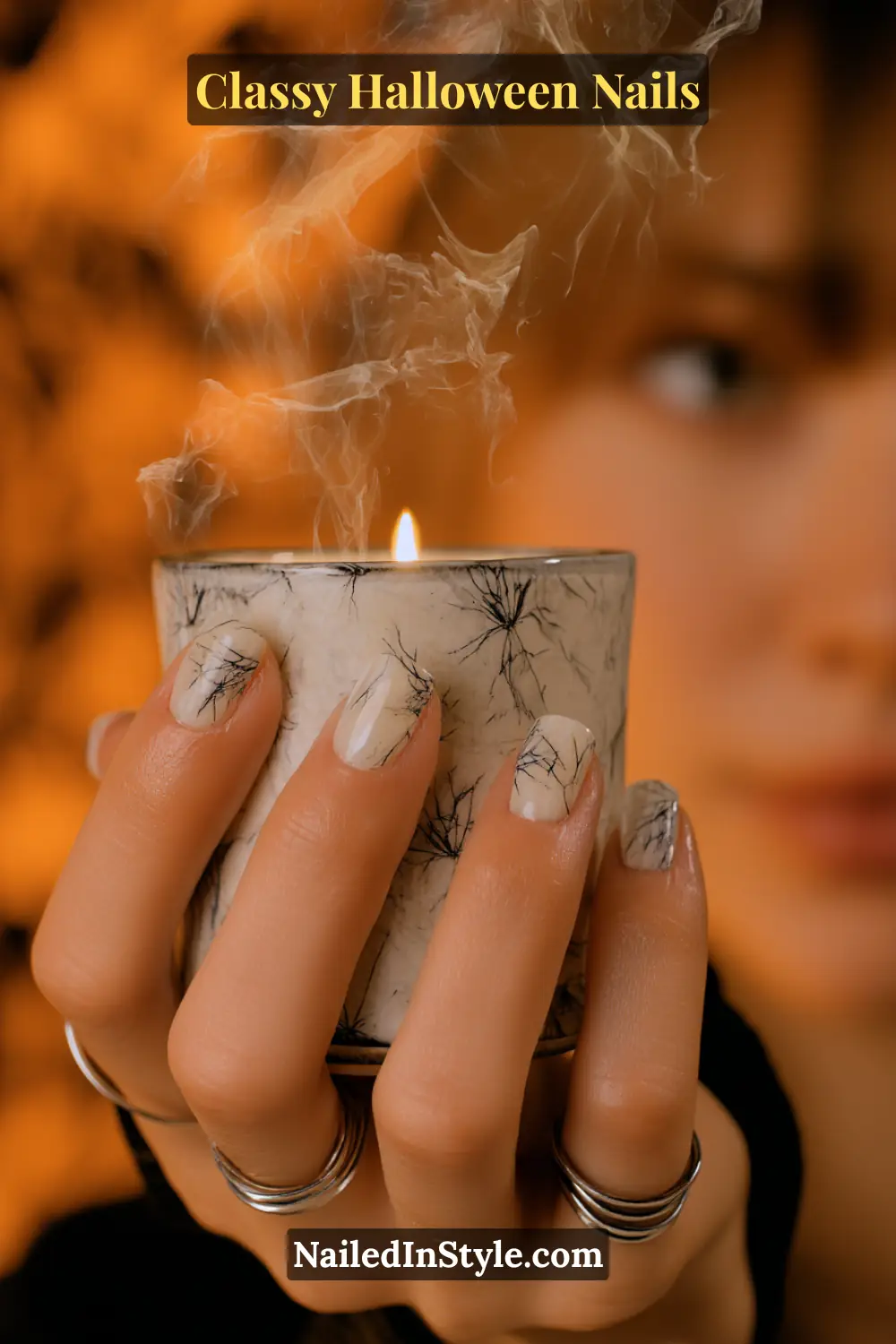 Short squoval nails with a milky porcelain base veiled in wisps of smoky gray and raven ribbons — an airy, ethereal design echoing the curl of candle smoke.