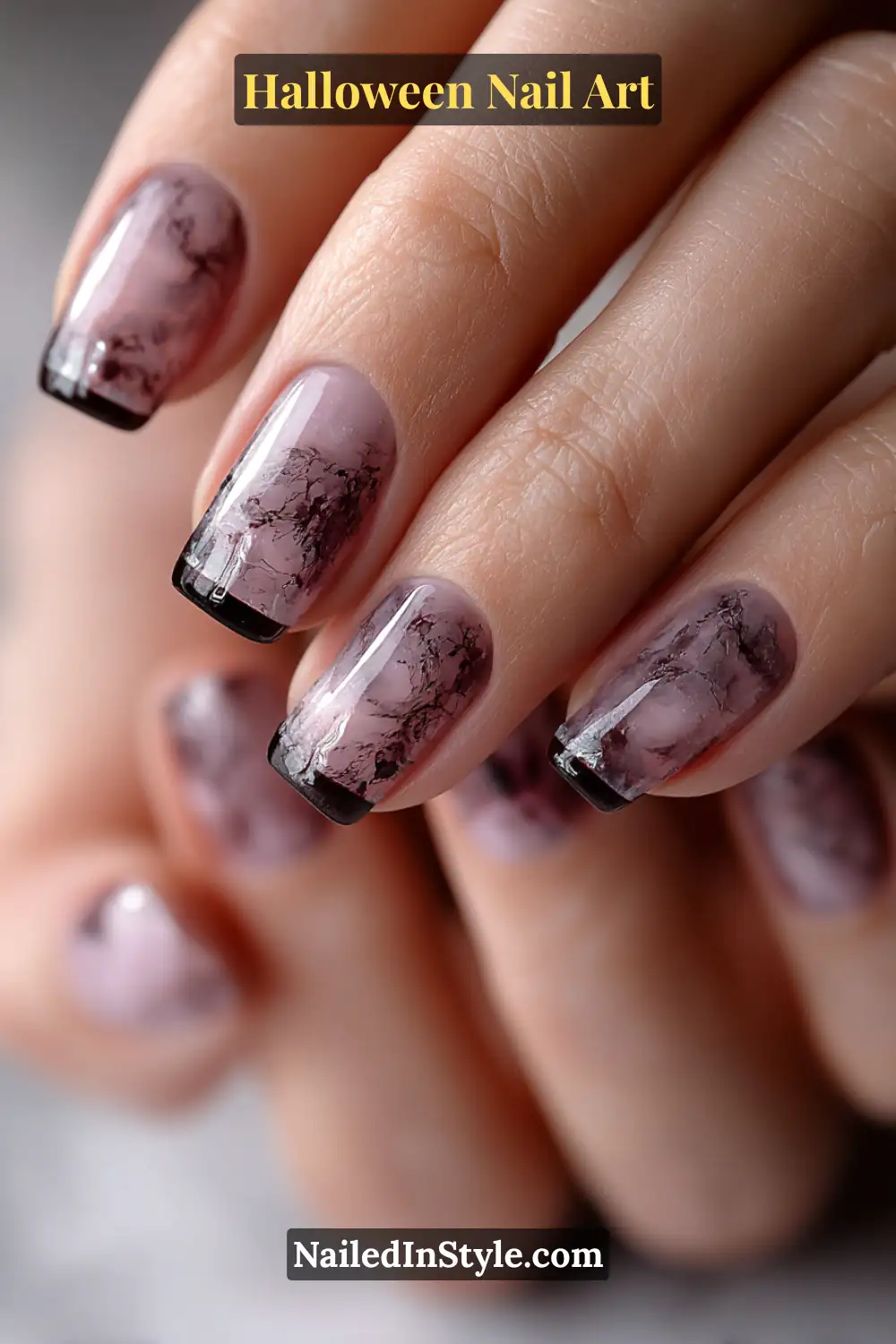 Short squoval nails with a milky porcelain base and ethereal smoke-like marble swirls in soft raven tones, giving a misty Halloween elegance.