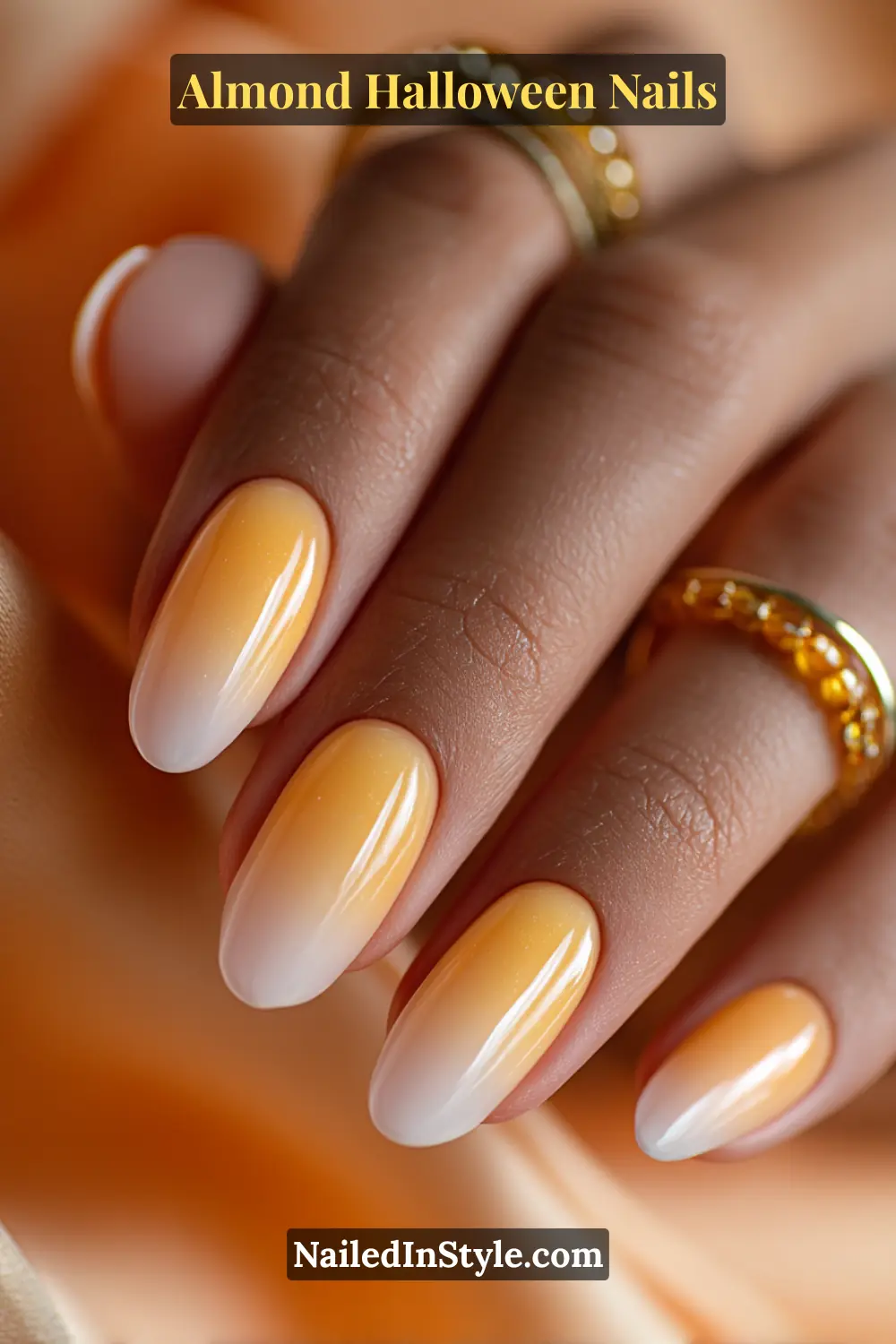 Close-up almond nails with ombre blending white to yellow to tangerine jelly tones, softly airbrushed glow at the center, glossy finish, Almond Halloween Nails.