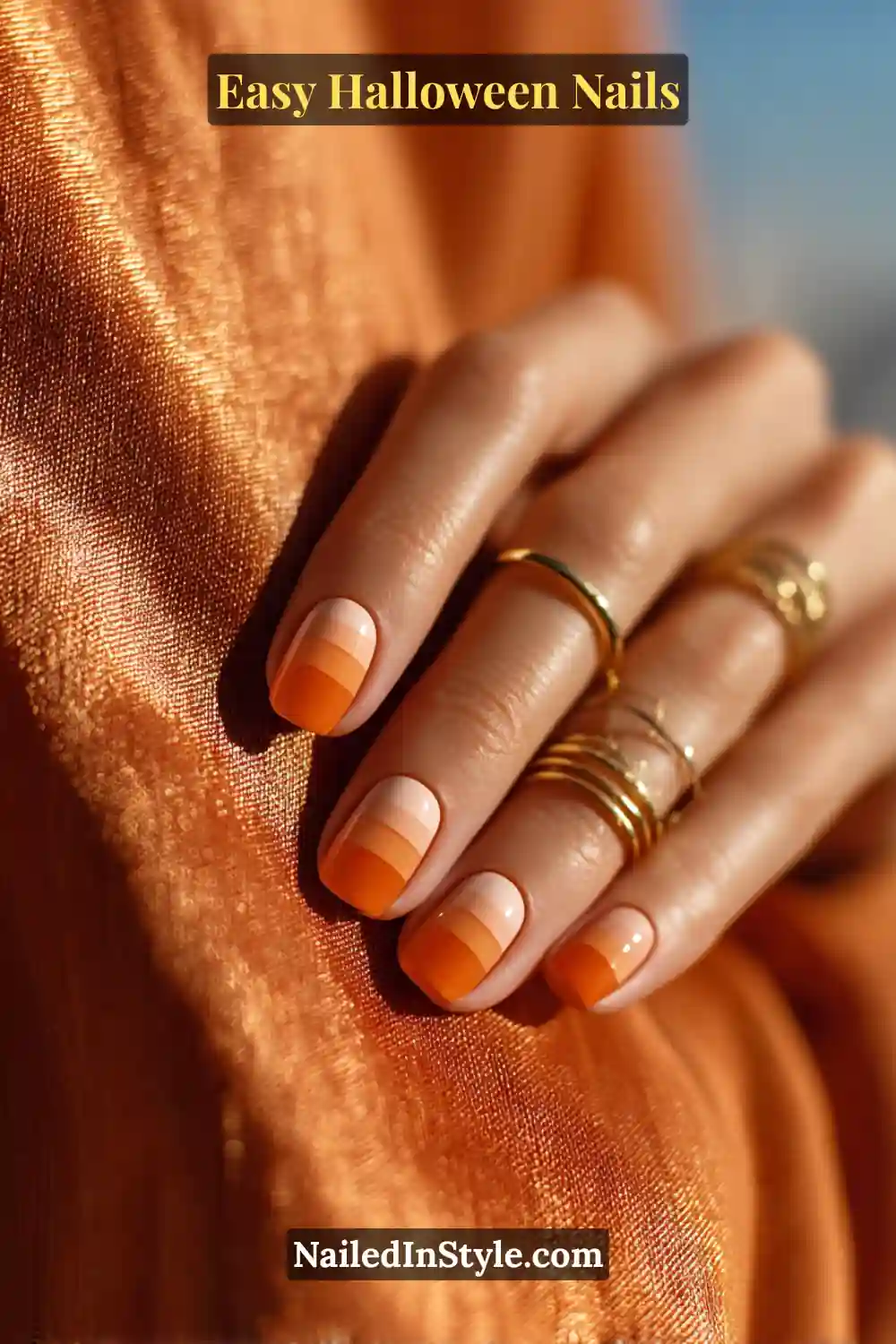 Short square nails painted with three stacked stripes in ivory, saffron, and tangerine shades at the tip, finished in a smooth lacquer shine for Easy Halloween Nails.
