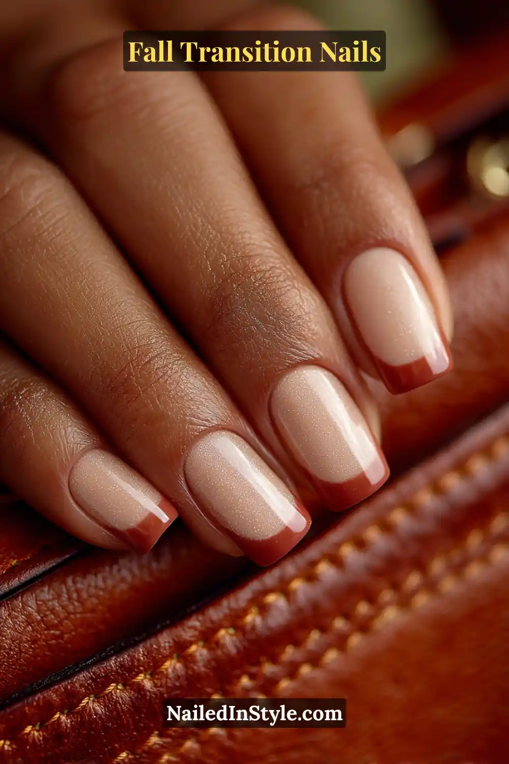 Medium square nails with a soft gradient French design blending cream and cinnamon tones, styled elegantly against a rich brown leather clutch.