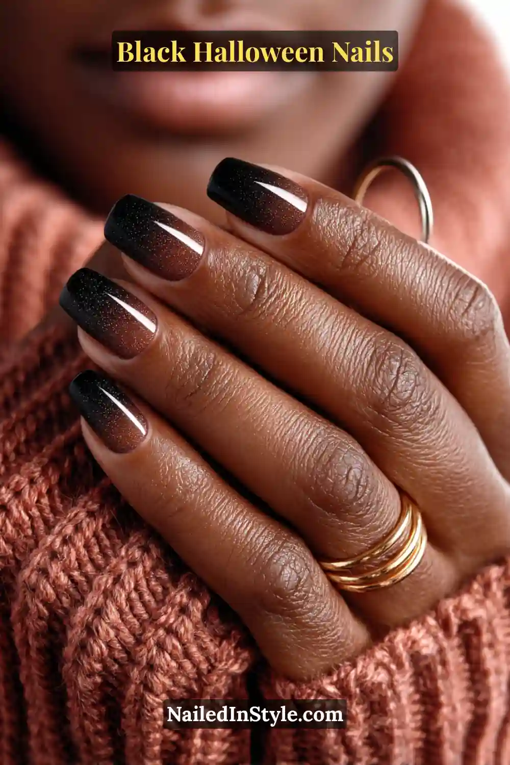 Medium round nails with a smooth aura gradient from warm clove brown near the cuticle to soft black at the tips; glossy finish with copper rings and a cozy knit backdrop.