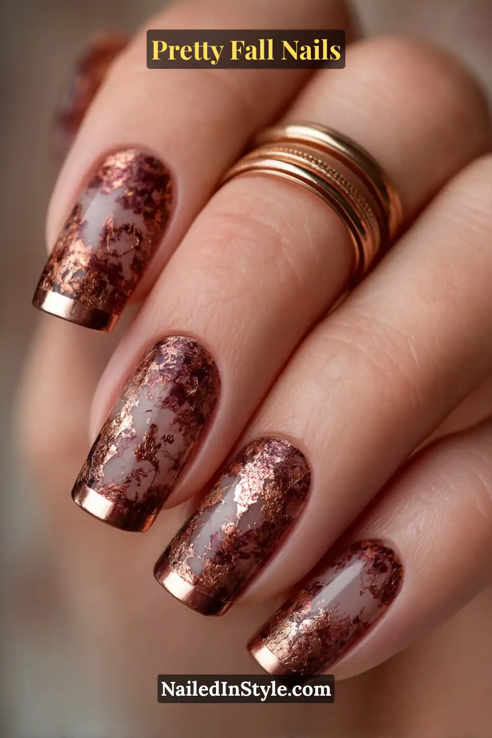 Medium almond nails glazed in a smoky cinnamon base with torn copper leaf foils at the tips, creating a burnished 3D texture that glows against olive to deep skin tones and catches autumn light beautifully.