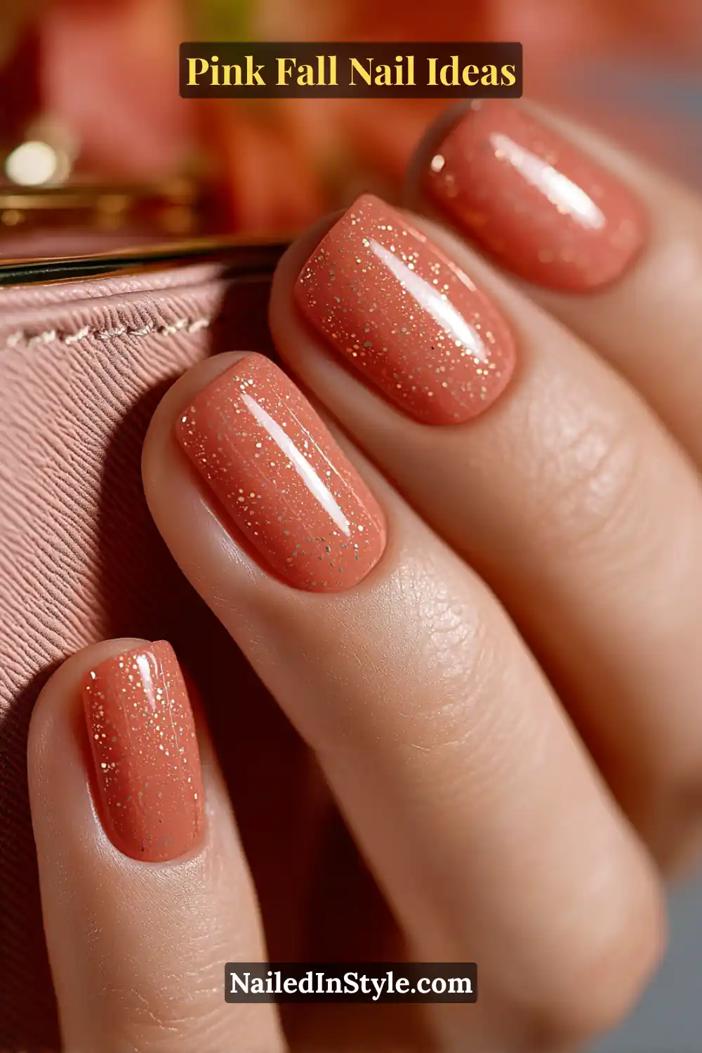 Pink Fall Nail Ideas: Chic, Fast & Photogenic 2025 11 Short squoval nails in glossy coral with raised golden pin-dot accents that catch the light like confetti, styled beside a soft blush clutch.