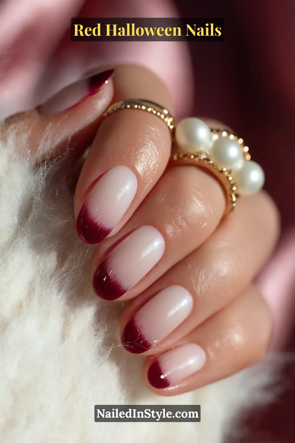 Short almond nails with a sheer milky base softly blended into cranberry-tinted tips; glowy finish and plush gradient effect; paired with gold and pearl rings; best suited for fair to olive skin tones.