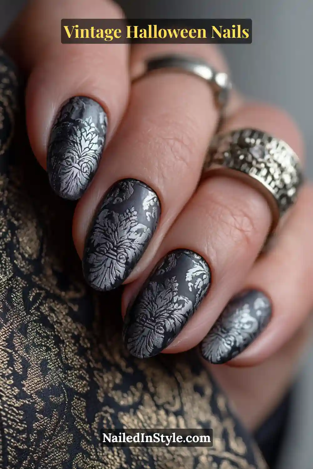Medium oval nails in smoky gray with silver damask pattern stamping and a matte finish, capturing a refined vintage Halloween parlor aesthetic.